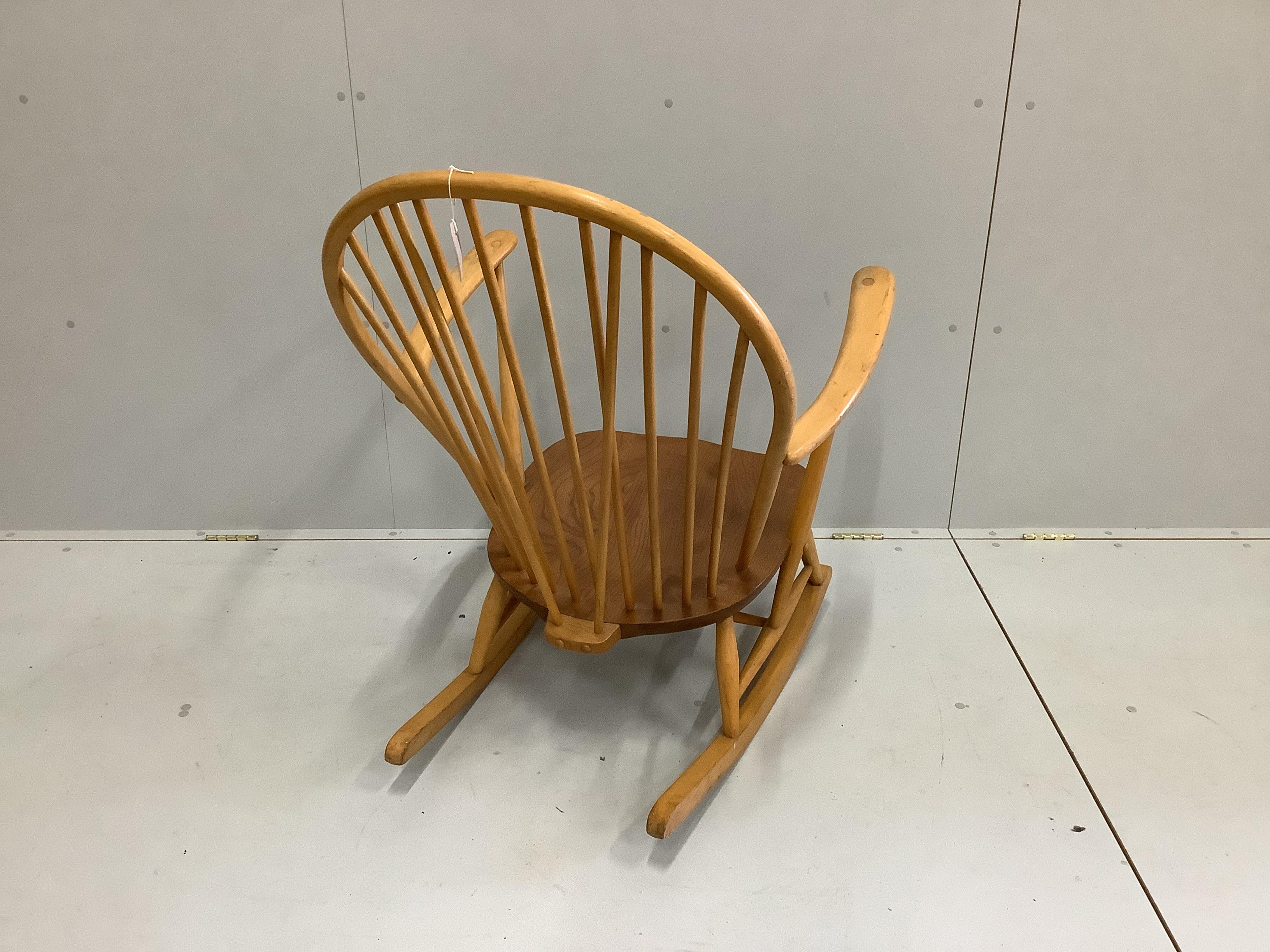 An Ercol elm and beech comb back rocking armchair, width 73cm, depth 78cm, height 95cm